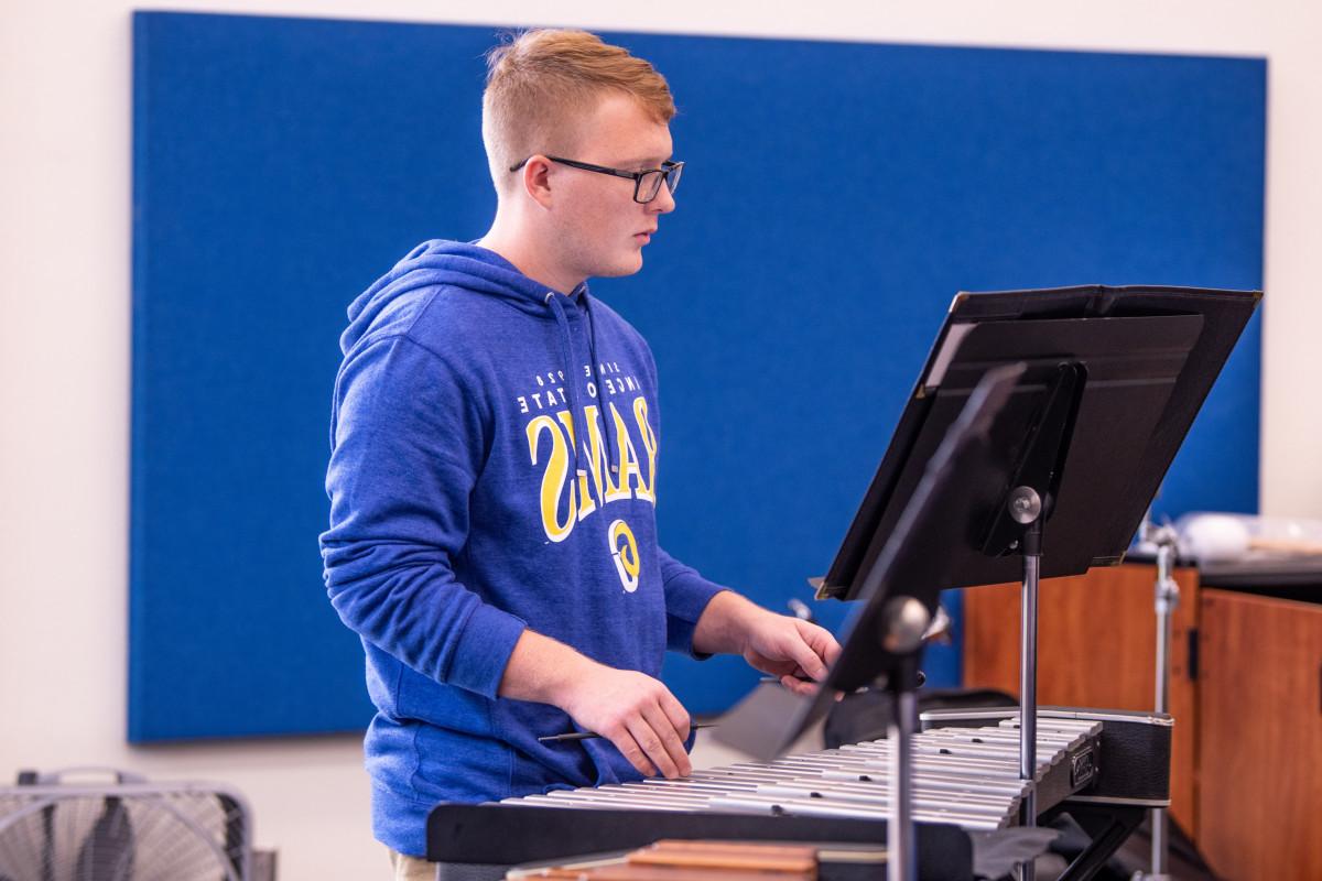 Student plays his instrument in class.