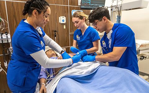 ASU nursing students practicing how to help a patient during pregnancy.