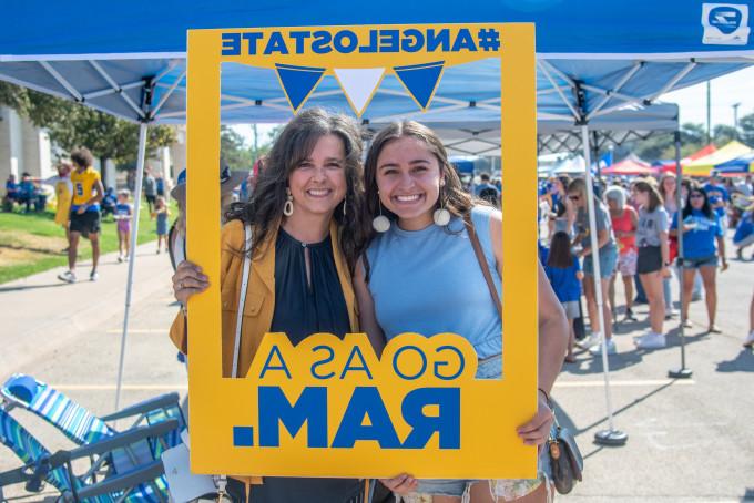A student and her mother taking a photo at a Ram Jam tailgate